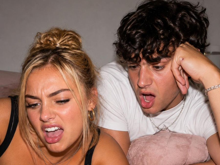 A couple recoiling at the same phone screen